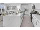 Modern kitchen featuring a large island with quartz countertops, white cabinetry, and stainless steel appliances at 10292 Fragrant Apple Ct, Las Vegas, NV 89141