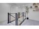 Bright upstairs landing with modern metal railing, large plant, and white walls offering a welcoming space at 10292 Fragrant Apple Ct, Las Vegas, NV 89141
