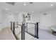 Bright upstairs landing with modern metal railing, large plant, and white walls offering a welcoming space at 10292 Fragrant Apple Ct, Las Vegas, NV 89141