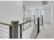 Upstairs landing with modern metal railing, papasan chair and a view, perfect for relaxation and leisure at 10292 Fragrant Apple Ct, Las Vegas, NV 89141
