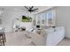Inviting living space with large windows, a ceiling fan, and comfortable seating at 10292 Fragrant Apple Ct, Las Vegas, NV 89141