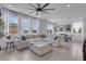 Bright living room with a large sectional, neutral walls, and lots of natural light at 10292 Fragrant Apple Ct, Las Vegas, NV 89141
