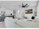 Bright and airy living room featuring a view of the kitchen and contemporary decor at 10292 Fragrant Apple Ct, Las Vegas, NV 89141