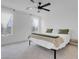 Bright main bedroom features a ceiling fan, plush carpet, and natural light from the windows at 10292 Fragrant Apple Ct, Las Vegas, NV 89141