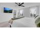Light-filled main bedroom includes a television, neutral paint, and ensuite access at 10292 Fragrant Apple Ct, Las Vegas, NV 89141