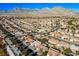 Overhead view of a community showcasing lush green golf courses and beautiful homes in a picturesque setting at 10628 Mission Lakes Ave, Las Vegas, NV 89134