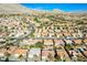 Scenic aerial view of a neighborhood with lush green golf courses and mountain views at 10628 Mission Lakes Ave, Las Vegas, NV 89134