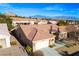 Aerial view showcasing the home's tile roof, desert landscaping, and two car garage at 10628 Mission Lakes Ave, Las Vegas, NV 89134