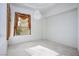 Bright bedroom featuring a decorative chandelier, neutral carpet, and a window with elegant drapes at 10628 Mission Lakes Ave, Las Vegas, NV 89134