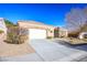 Exterior featuring a large concrete driveway and desert landscaping at 10628 Mission Lakes Ave, Las Vegas, NV 89134