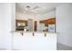 Bright kitchen area with bar seating, granite countertops, and built-in appliances at 10628 Mission Lakes Ave, Las Vegas, NV 89134