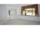 Bright living room featuring a large window with patterned drapes and view to exterior space at 10628 Mission Lakes Ave, Las Vegas, NV 89134