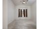 Well-lit room featuring neutral-toned walls, plush carpeting, and window with draperies at 10628 Mission Lakes Ave, Las Vegas, NV 89134