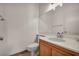 Well-lit half-bathroom featuring a modern vanity with a white countertop, wood cabinetry, and a large mirror at 10952 Napa Ridge Dr, Las Vegas, NV 89144