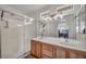 Bright bathroom showcasing a double vanity, large mirrors, and separate shower at 10952 Napa Ridge Dr, Las Vegas, NV 89144