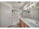 Bright bathroom showcasing a double vanity, large mirrors, and separate shower at 10952 Napa Ridge Dr, Las Vegas, NV 89144