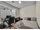Cozy bedroom featuring a workspace with desk, chair, and comfortable sleeping area with bed and sofa at 10952 Napa Ridge Dr, Las Vegas, NV 89144