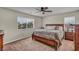 Serene bedroom with a large bed, neutral decor, and abundant natural light from two windows at 10952 Napa Ridge Dr, Las Vegas, NV 89144