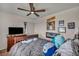 Cozy bedroom featuring a dresser with a TV, a comfortable bed, and personalized wall decorations at 10952 Napa Ridge Dr, Las Vegas, NV 89144