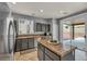 Kitchen featuring stainless steel appliances, granite countertops, and sliding glass doors to the backyard at 10952 Napa Ridge Dr, Las Vegas, NV 89144