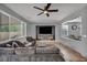 Spacious living room featuring a modern ceiling fan, comfortable seating, and large windows for ample natural light at 10952 Napa Ridge Dr, Las Vegas, NV 89144
