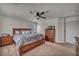 Comfortable main bedroom featuring a ceiling fan, ensuite bathroom and carpet flooring at 10952 Napa Ridge Dr, Las Vegas, NV 89144