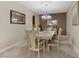 Formal dining room features neutral tones, chandelier, and modern decor at 1272 Olivia Pkwy, Henderson, NV 89011