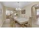 Spacious dining room with chandelier, adjacent to the staircase and kitchen at 1272 Olivia Pkwy, Henderson, NV 89011
