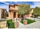 Attractive home exterior with lush lawn, detailed brick pillars, and stylish outdoor lighting at 1272 Olivia Pkwy, Henderson, NV 89011