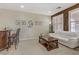 Comfortable living room with a bar, white sofa, plantation shutters, and stylish decor at 1272 Olivia Pkwy, Henderson, NV 89011
