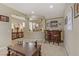 Spacious living area featuring a bar, an ornate staircase, and ample natural light at 1272 Olivia Pkwy, Henderson, NV 89011