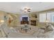 Bright living room with fireplace, large sofa, and stairs to upper level at 1272 Olivia Pkwy, Henderson, NV 89011