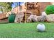 Close-up of backyard putting green with artificial turf and decorative rocks at 1272 Olivia Pkwy, Henderson, NV 89011