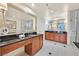 Bright bathroom with double vanity, large mirrors, and glass walk-in shower at 135 E Harmon Ave # 1401, Las Vegas, NV 89109