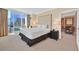 This spacious bedroom has a large bed, city views from floor-to-ceiling windows, and an adjacent sitting room at 135 E Harmon Ave # 1401, Las Vegas, NV 89109