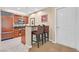Kitchenette with stainless fridge, bar, granite counters, wood cabinets, and breakfast bar seating at 135 E Harmon Ave # 1401, Las Vegas, NV 89109