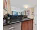 Contemporary kitchenette features granite counters, wood cabinets, and stainless Bosch dishwasher at 135 E Harmon Ave # 1401, Las Vegas, NV 89109
