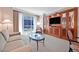 Bright living room showcases a comfortable seating area and city views from large windows at 135 E Harmon Ave # 1401, Las Vegas, NV 89109