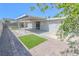 Backyard featuring brick pavers, artificial turf, a covered patio, and modern doors at 1413 Culley St, Las Vegas, NV 89110