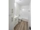 Bright bathroom featuring a vanity, toilet, and shower-tub combo with white tile at 1413 Culley St, Las Vegas, NV 89110