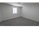 A minimalist bedroom featuring neutral walls, carpet, and a window allowing natural light at 1413 Culley St, Las Vegas, NV 89110