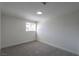 This bedroom has neutral decor, gray carpet, white walls, and a window at 1413 Culley St, Las Vegas, NV 89110