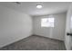 A bright bedroom featuring plush gray carpeting and a window providing natural light at 1413 Culley St, Las Vegas, NV 89110