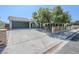 Single Gathering home with a large driveway and mature trees providing shade to the property at 1413 Culley St, Las Vegas, NV 89110