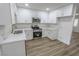 Modern kitchen with white cabinetry, stainless steel appliances, and marble countertops at 1413 Culley St, Las Vegas, NV 89110