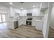 Beautiful kitchen with white cabinets, stainless steel appliances and wood-look flooring at 1413 Culley St, Las Vegas, NV 89110