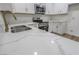 Bright kitchen boasts white marble countertops, stainless steel appliances, and modern gold fixtures at 1413 Culley St, Las Vegas, NV 89110