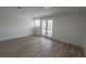Spacious living room featuring stylish wood-look flooring and French doors to outdoor space at 1413 Culley St, Las Vegas, NV 89110