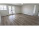 Spacious living room featuring stylish wood-look flooring and French doors to outdoor space at 1413 Culley St, Las Vegas, NV 89110