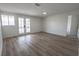 Bright, open living room with modern wood-look floors and french doors leading to outdoor space at 1413 Culley St, Las Vegas, NV 89110